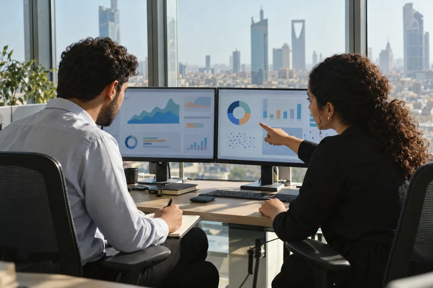 Two engineers reviewing cloud and AI dashboards